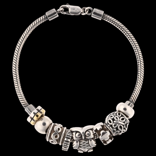 1411 - JENS JOHS AAGAARD - a Danish sterling silver snake link charm bracelet, with 7 silver charms, bracel... 