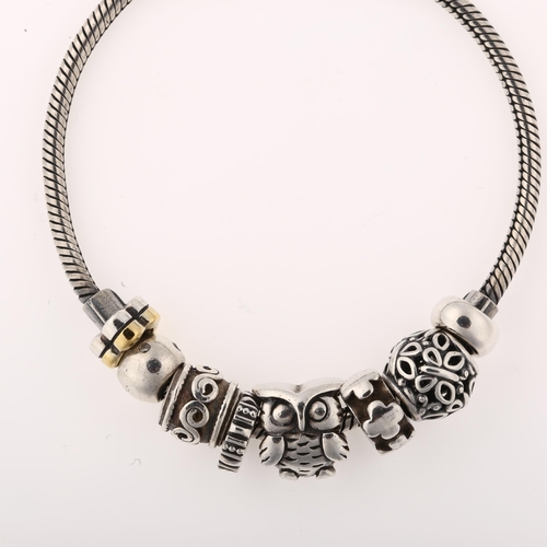 1411 - JENS JOHS AAGAARD - a Danish sterling silver snake link charm bracelet, with 7 silver charms, bracel... 