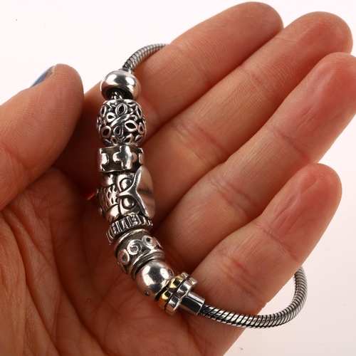 1411 - JENS JOHS AAGAARD - a Danish sterling silver snake link charm bracelet, with 7 silver charms, bracel... 