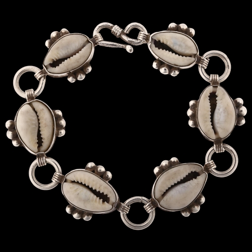 1415 - A sterling silver cowrie shell bracelet, length 19cm, 26.2g