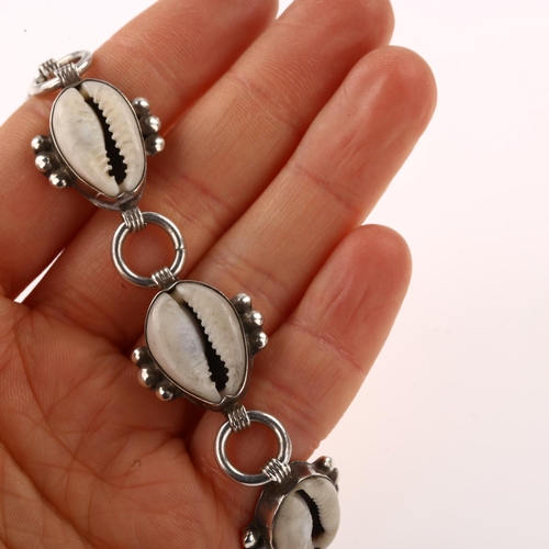 1415 - A sterling silver cowrie shell bracelet, length 19cm, 26.2g