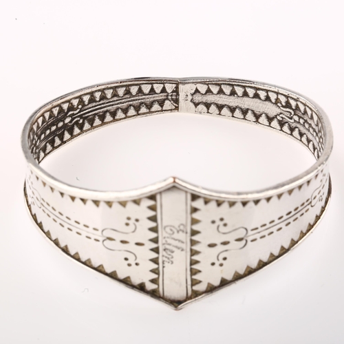 1416 - A Scandinavian Viking Revival bangle, unmarked silver settings with relief embossed decoration, sett... 