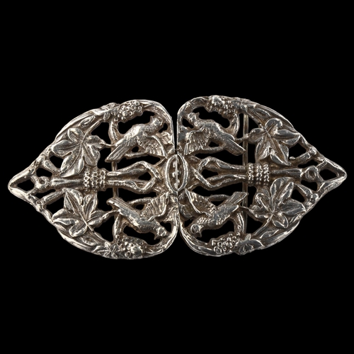 1440 - An Arts and Crafts unmarked silver nurse's buckle, relief and pierced bird and leaf decoration, leng... 