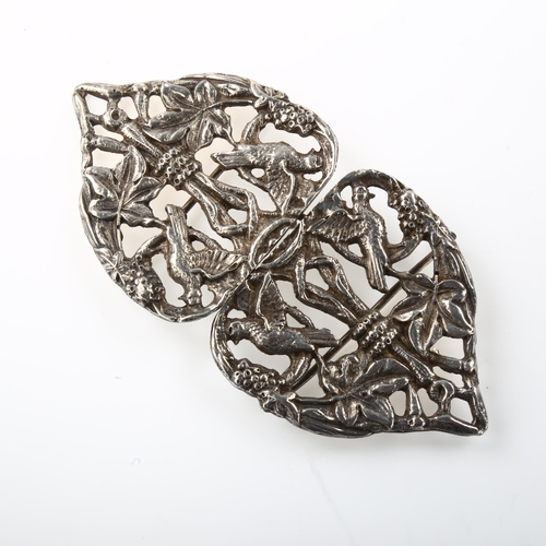 1440 - An Arts and Crafts unmarked silver nurse's buckle, relief and pierced bird and leaf decoration, leng... 