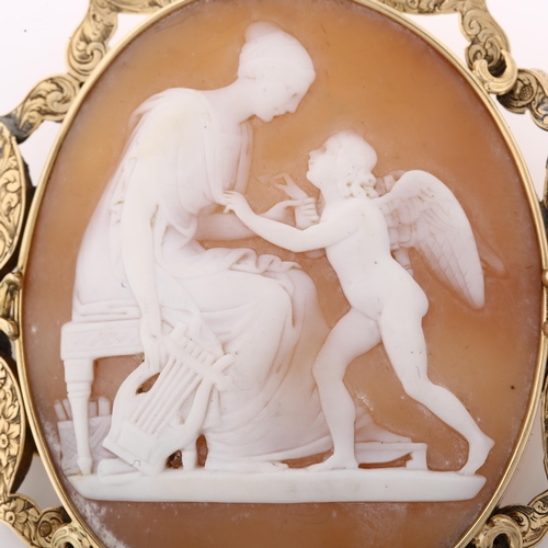 1348 - A large Victorian shell cameo brooch, relief carved depicting Erato and Eros, in unmarked gold flora... 