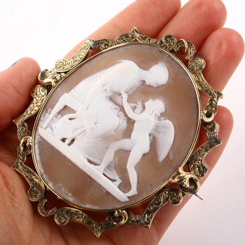 1348 - A large Victorian shell cameo brooch, relief carved depicting Erato and Eros, in unmarked gold flora... 