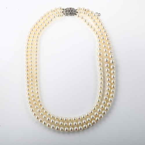 1351 - ***WITHDRAWN***  A Vintage triple-strand cultured pearl necklace, with 9ct white gold ruby and diamo... 