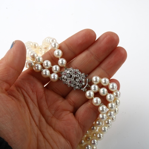 1351 - ***WITHDRAWN***  A Vintage triple-strand cultured pearl necklace, with 9ct white gold ruby and diamo... 