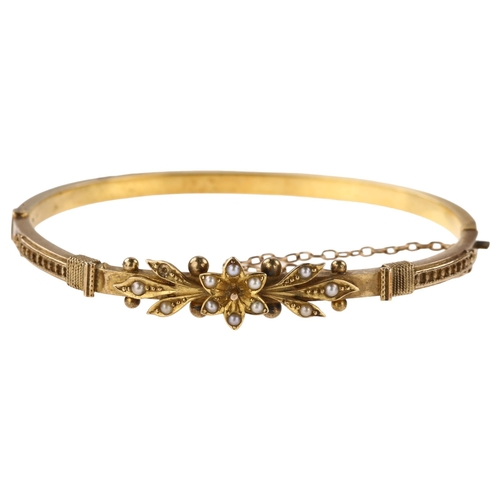 1357 - A Victorian 15ct gold split pearl hinged bangle, with flowerhead motif, internal circumference 16cm,... 