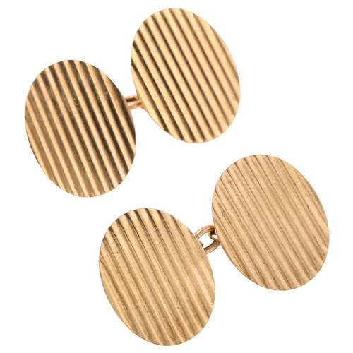 1365 - A pair of late 20th century 9ct gold cufflinks, oval panels with fluted decoration, maker's marks E ... 