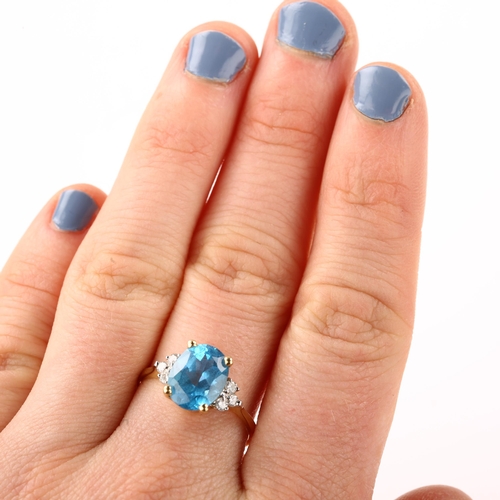 1370 - A 14ct gold blue topaz and diamond dress ring, set with oval mixed-cut topaz and modern round brilli... 