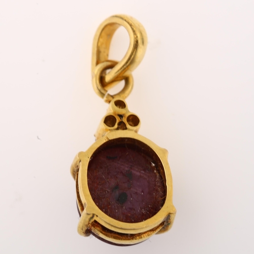 1377 - A modern star ruby and diamond pendant, unmarked gold settings with oval cabochon ruby and modern ro... 