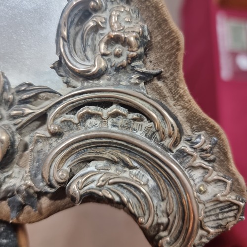 1579 - A large Edwardian silver-fronted dressing table mirror, with relief embossed foliate decoration and ... 