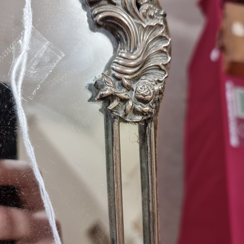 1579 - A large Edwardian silver-fronted dressing table mirror, with relief embossed foliate decoration and ... 