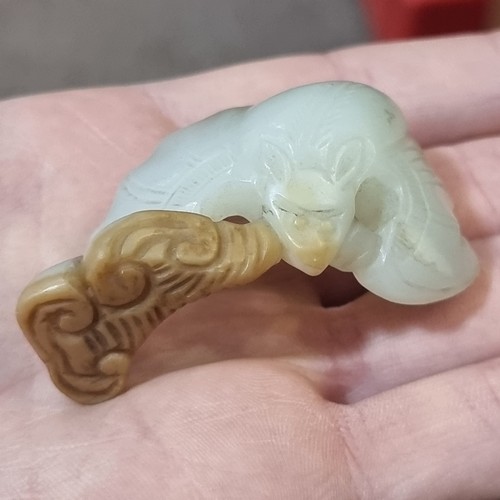 180 - A Chinese carved pale green and russet jade bat group, length 6.5cm