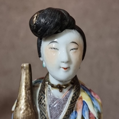 197 - A 19th century Chinese porcelain figure with fine enamel decoration, height 25cm