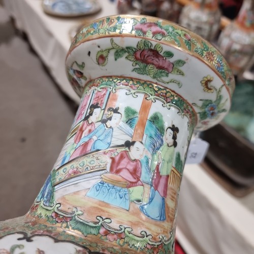 22 - A Chinese Canton famille rose ceramic rouleau vase, with hand painted and enamelled figures in court... 