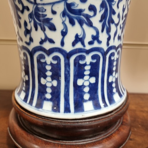 198 - A large Chinese blue and white baluster vase with floral decoration, on wooden stand, height of vase... 