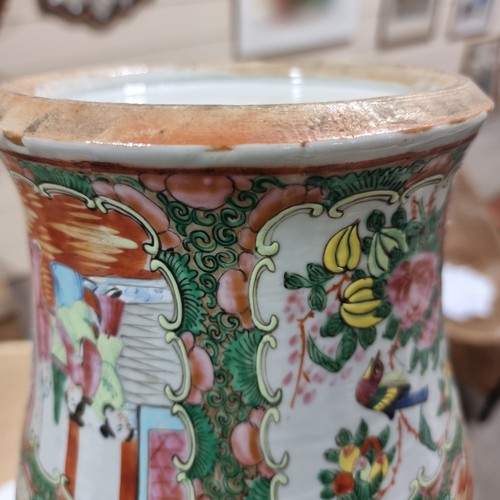 23 - A Chinese Canton famille rose vase and cover, with hand painted and enamelled figures in courtyard a... 