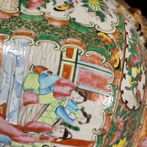 23 - A Chinese Canton famille rose vase and cover, with hand painted and enamelled figures in courtyard a... 