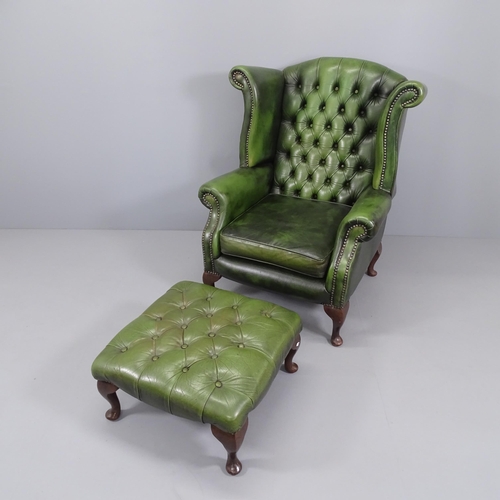 2007 - A Green leather upholstered buttoned wing back fireside armchair and a matched green leather footsto... 