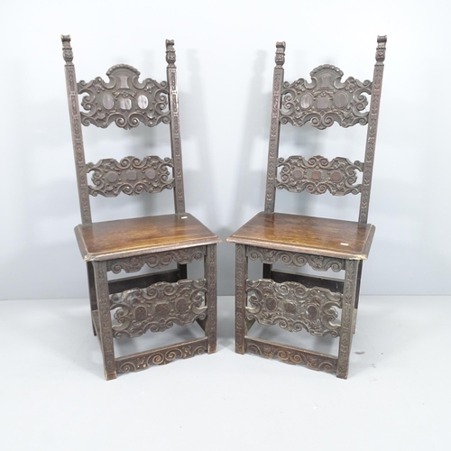 2009 - A pair of carved oak renaissance style hall chairs.