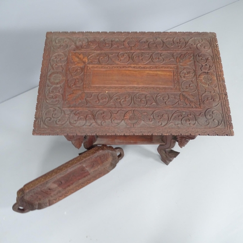 2026 - A Chinese hardwood two-tier occasional table with all-over carved decoration, 59x63x39cm, and matchi... 