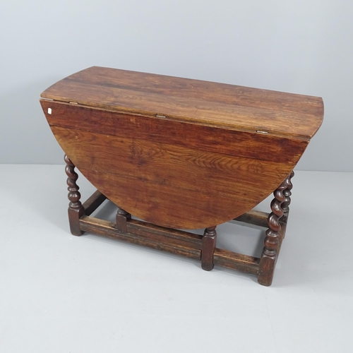 2027 - An antique oak oval gate-leg table, with barley twist legs. 117x74x47cm