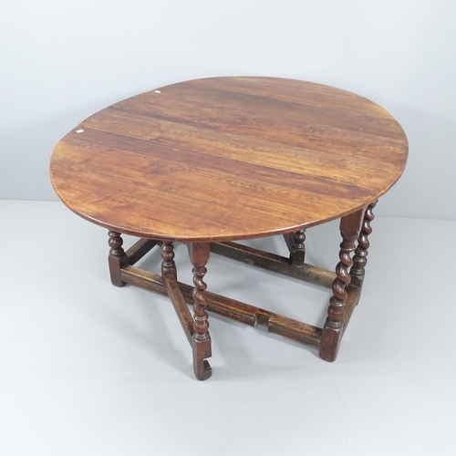 2027 - An antique oak oval gate-leg table, with barley twist legs. 117x74x47cm