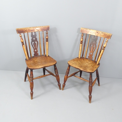 2030 - A pair of antique elm-seated dining chairs.