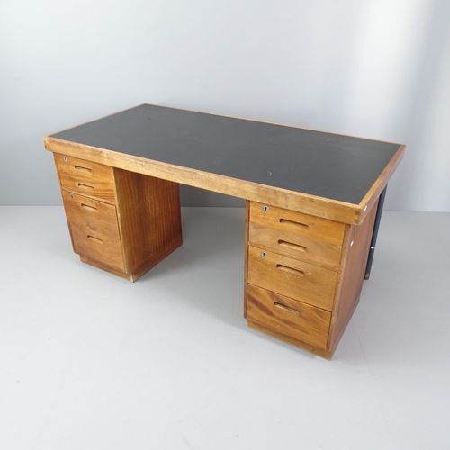 2033 - A mid-century teak twin pedestal desk, with inset black faux-leather skiver and eight drawers. Overa... 