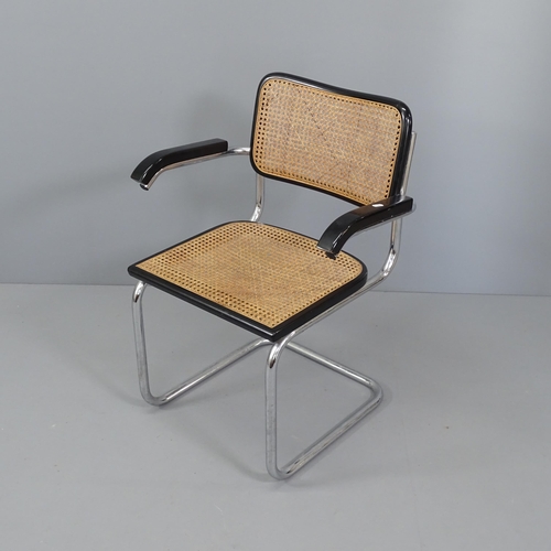 2034 - A mid-century desk chair in the manner of Marcel Breuer, on tubular steel frame with cane panels.