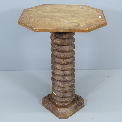 2042 - A French elm octagonal occasional table, mounted on spiral turn central column with carved base. 58x... 