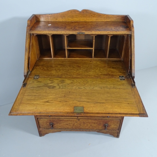 2049 - An early 20th century oak Bureau, the fall front revealing a fitted interior with three drawers belo... 