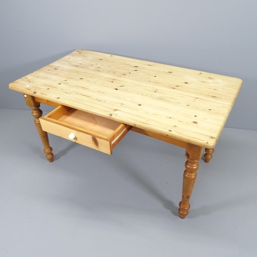 2055 - A modern pine farmhouse kitchen table, with single drawer and raised on turned legs. 140x75x80cm