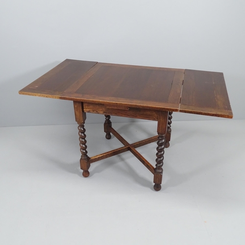 2057 - A 1920s oak draw-leaf dining table, on barley-twist legs with x-shaped stretcher. 76 (extending to 1... 