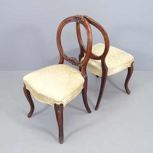 2070 - A set of four mahogany and upholstered balloon back dining chairs, with carved decoration.