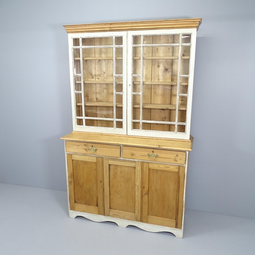 2073 - A vintage pine two-section dresser, with two glazed panelled doors and drawers and cupboards under. ... 