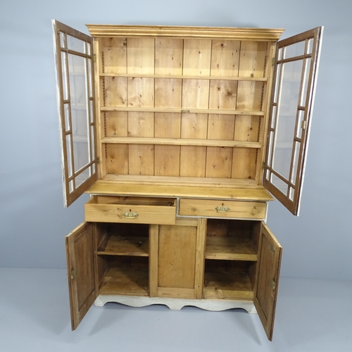 2073 - A vintage pine two-section dresser, with two glazed panelled doors and drawers and cupboards under. ... 