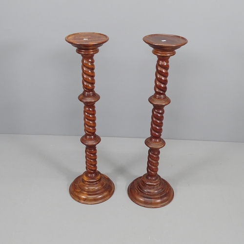 2081 - A pair of stained pine torchere stands. Height 100cm