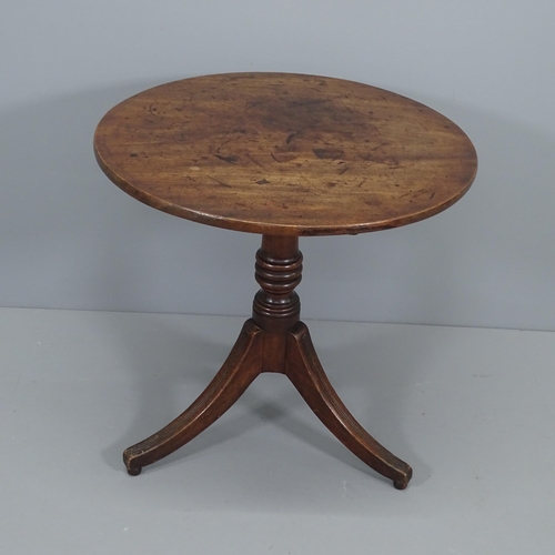 2082 - A Georgian mahogany tilt top table, raised on reeded tripod legs. W69cm H71cm