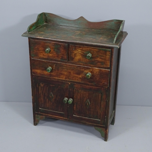 2091 - A 1920's green paint highlighted oak cabinet, with drawers and cupboards. 69x86x31cm