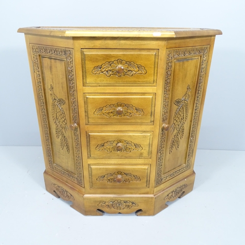 2116 - A Continental hardwood sideboard of canted form, with carved detail and 4 drawers between 2 cupboard... 