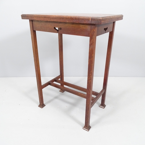 2124 - An Arts & Crafts oak fold over card table. 54x74x39cm.