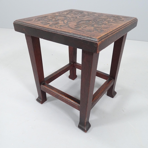 2125 - A small Arts & Crafts style oak stool with carved decoration. 31x36cm.