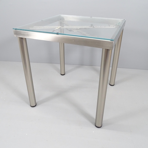 2136 - A contemporary glass topped table with unique steel gaming design. 72x77cm.