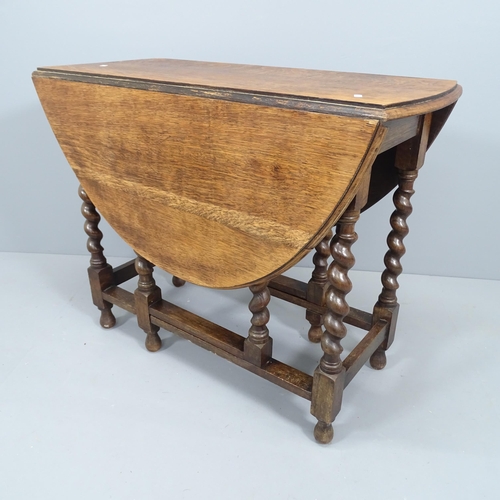 2150 - An antique oak gateleg table with barley twist legs. 90x74x45cm.