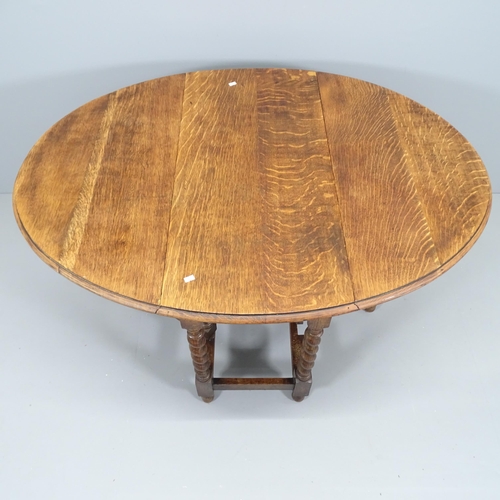 2150 - An antique oak gateleg table with barley twist legs. 90x74x45cm.