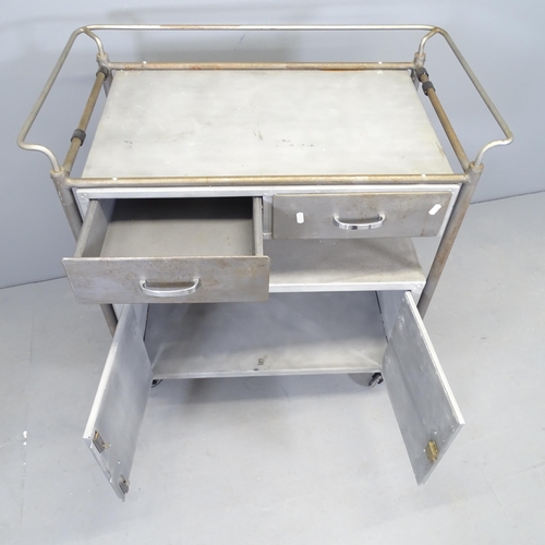 2510 - A vintage industrial aluminium medical trolley, with two drawers and cupboards under. 86x92x50cm