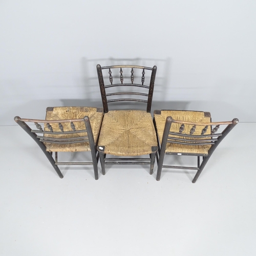 2108 - A pair of antique elm Morris style spindle back chairs with rush seats and ebonised frames, and anot... 